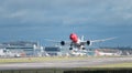 A Norwegian Airlines plane takes off from London Gatwick Airport, with jet wash w